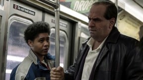 Colin Farrell and Rhenzy Feliz stand on a train together in The Penguin