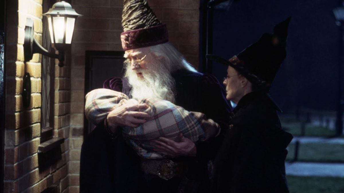 Richard Harris as Albus Dumbledore holds a baby and Maggie Smith as Professor Minerva McGonagall looks on in Harry Potter and the Sorcerer's Stone