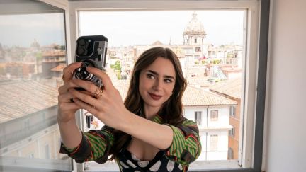 Lily Collins as Emily Cooper takes a selfie in her new Rome apartment in Emily In Paris season 4 part 2