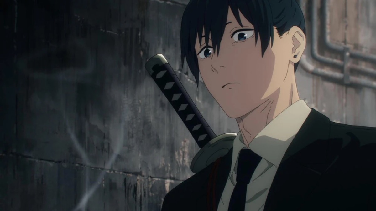 A suit wearing young man with a katana stands in an alley in "Chainsaw Man" 