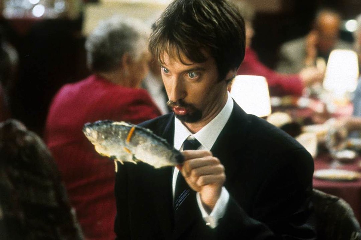 A man looks pensively at a fish in his hand in "Freddy Got Fingered" 