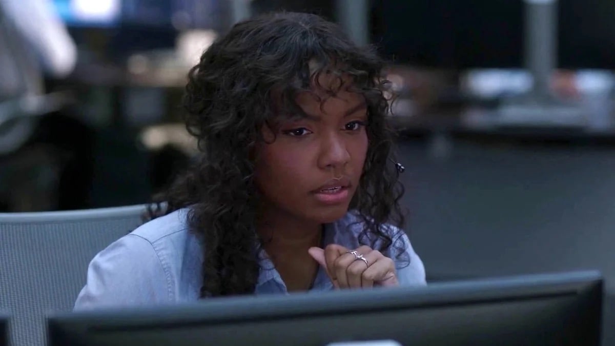 A woman sits at cubicle looking perplexed in "Lone Star 911"