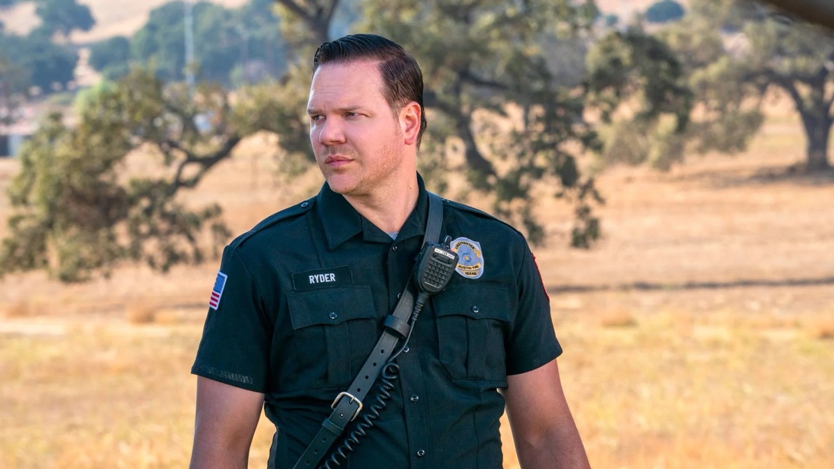 A cop stands outside in a field in "911 Lone Star"