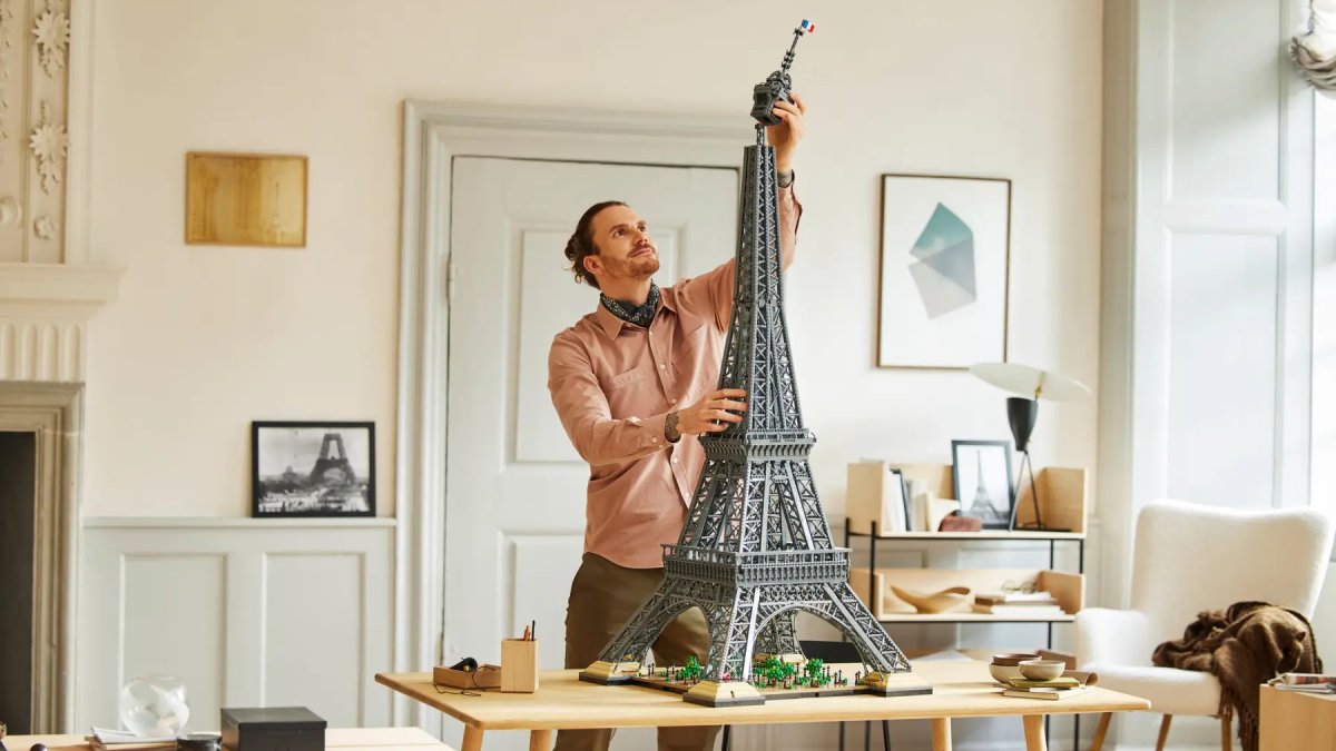 A person building the LEGO Eiffel Tower