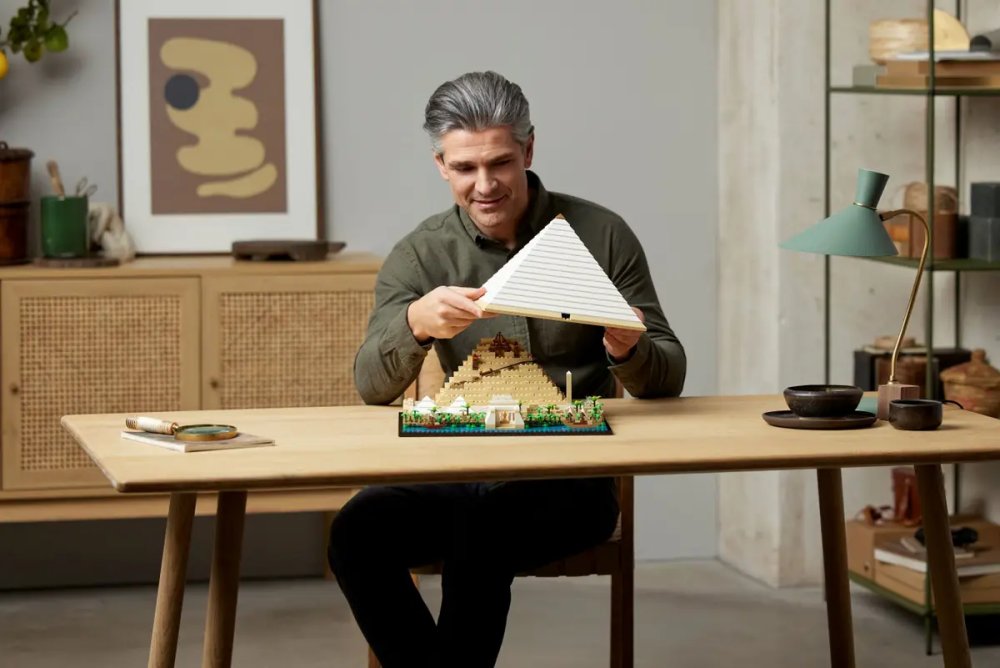 A man lifting the top of a LEGO Great Pyramid