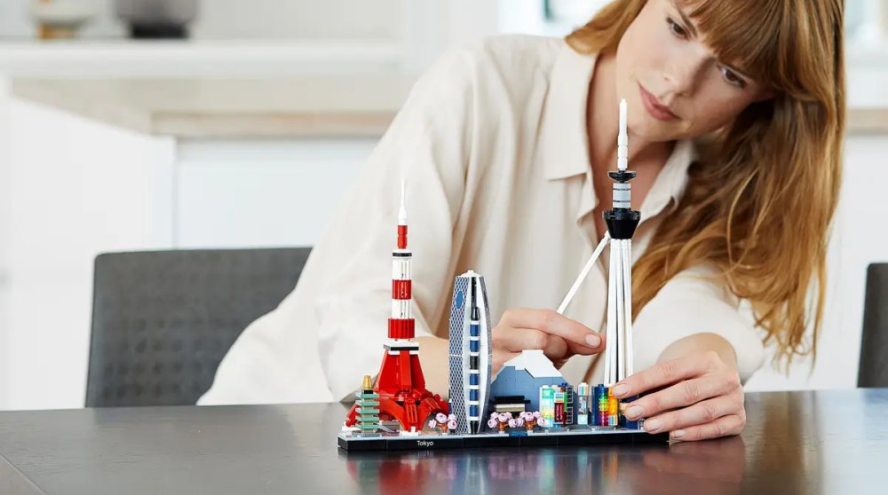 A woman putting together the LEGO Tokyo Skyline