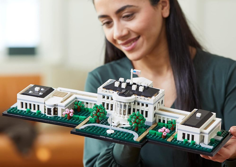 A woman holding the LEGO White House