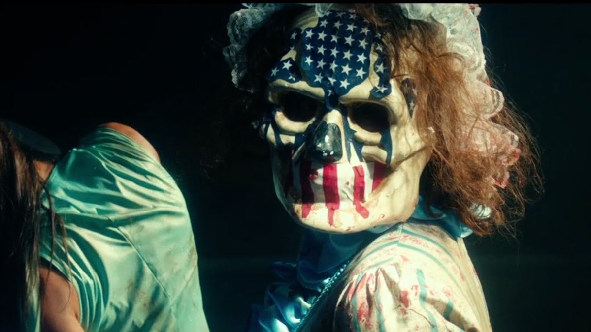 A criminal wearing a mask with the U.S. flag design in The Purge: Election Year