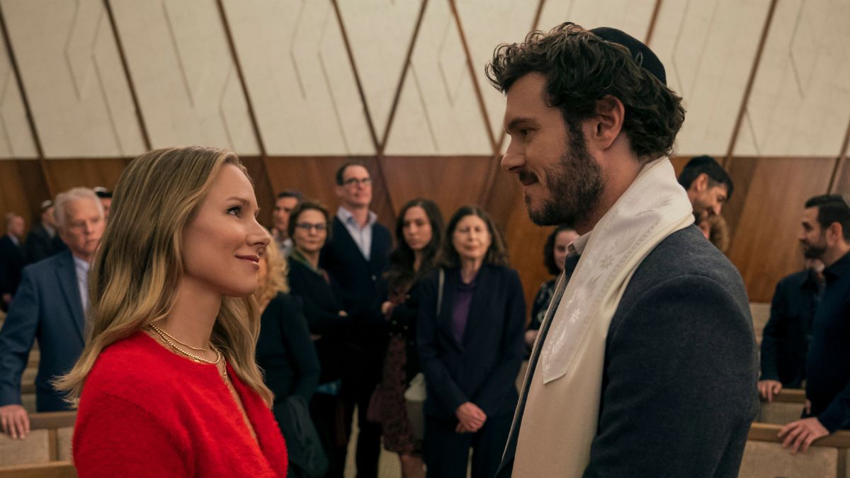 Kristen Bell as Joanne and Adam Brody as the rabbi Noah look at each other in a scene from Nobody Wants This on Netflix