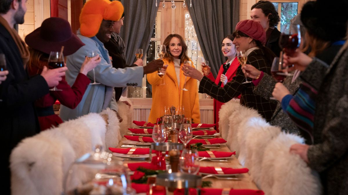 Philippine Leroy-Beaulieu as Sylvie Grateau leads everyone in a Christmas toast in Emily In Paris season 4 part 2