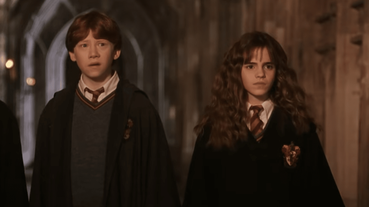 Rupert Grint and Emma Watson as Ron Weasley and Hermione Granger in Harry Potter and the Chamber of Secrets