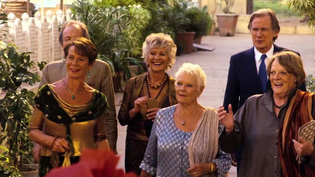 A group of older people smile and raise a glass