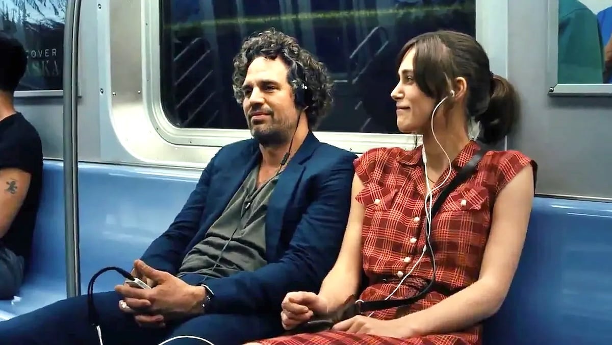 two people on a subway listening to music together