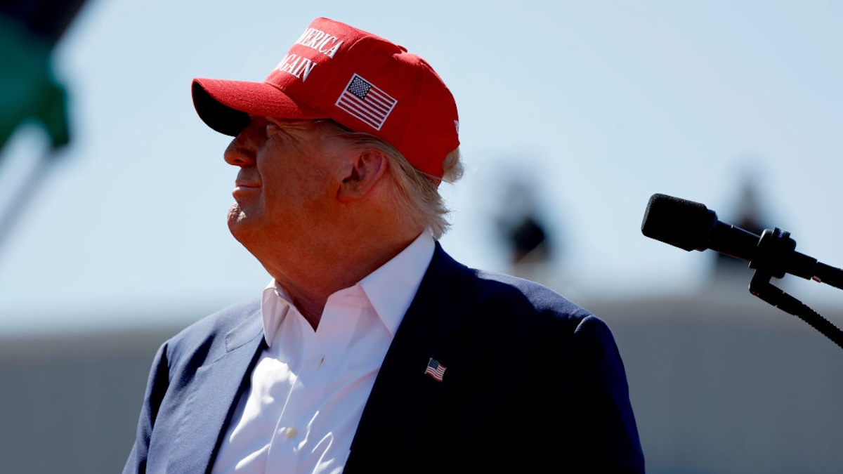 Republican presidential candidate former U.S. President Donald Trump watches a video on the display screen at a rally.