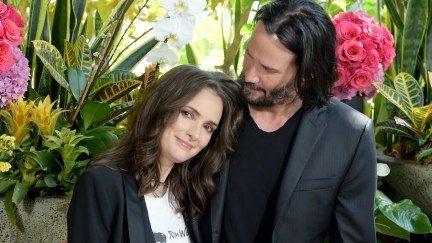 Keanu Reeves and Winona Ryder pose affectionately at a photo call