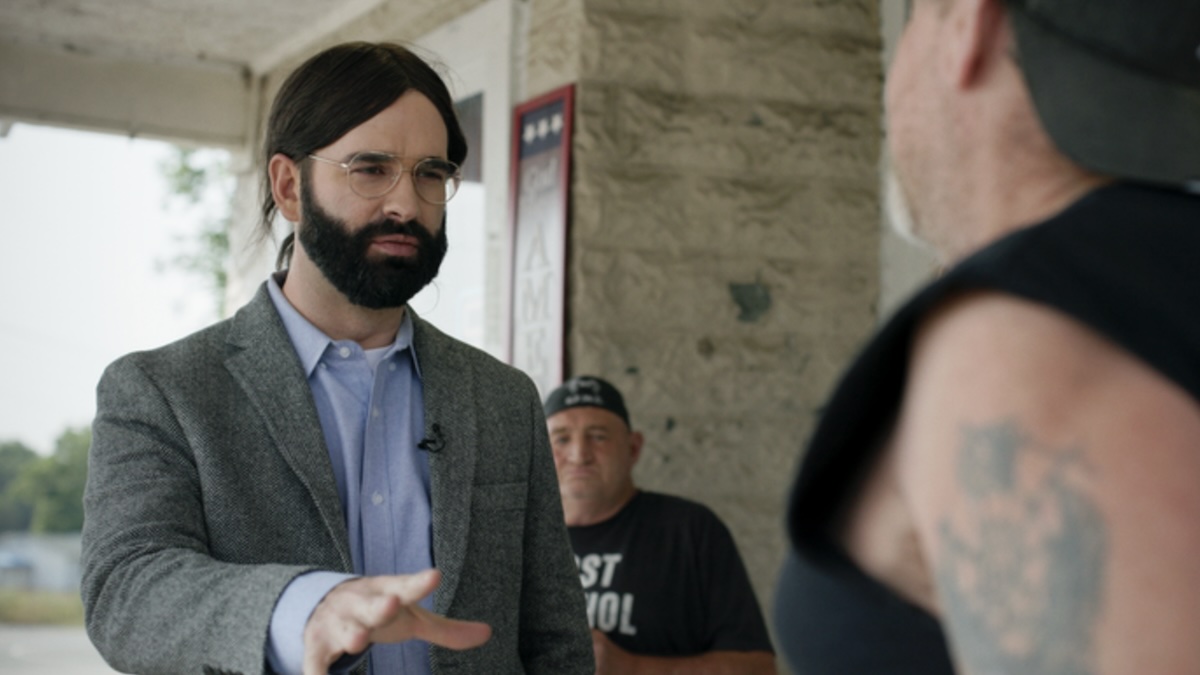 matt walsh wearing a bad wig and talking to someone