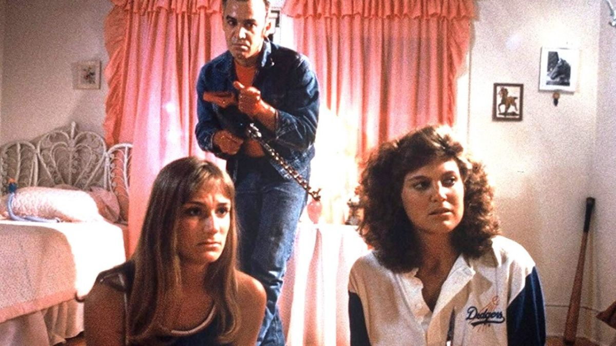 Two girls with a killer lurking behind them in The Slumber Party Massacre.