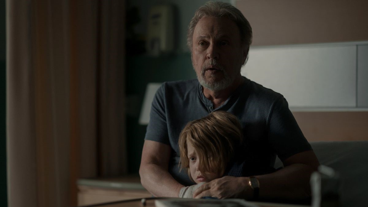 Billy Crystal and Jacobi Jupe in a scene from Apple TV+'s 'Before.' Crystal is holding a scared-looking Jupe close as he looks ahead at an unseen danger.