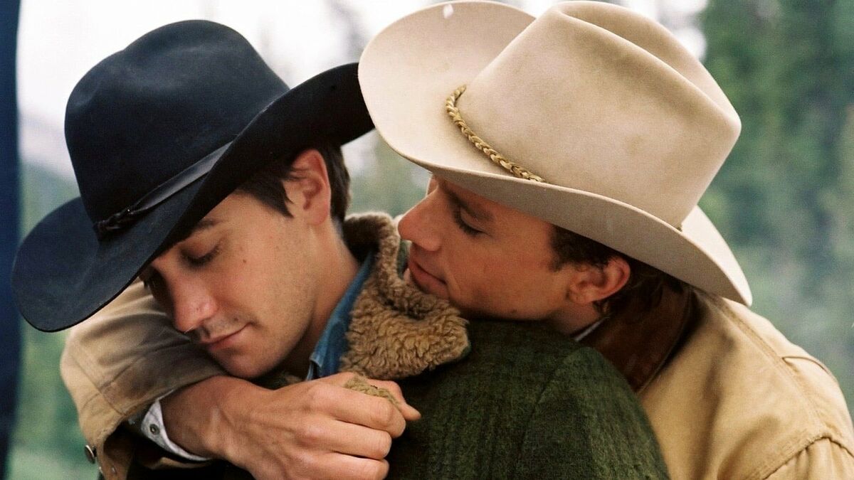 Two cowboy lovers hold each other in "Brokeback Mountain"