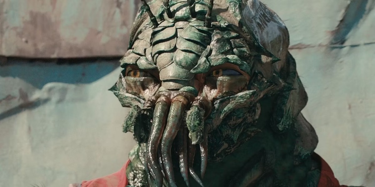 A crustacean like alien looks suspicious in "District 9"