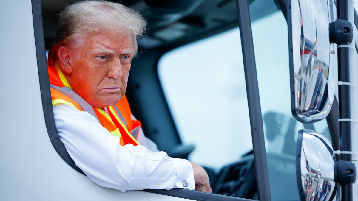 Donald Trump sitting a garbage truck during a visit to Green Bay, WI