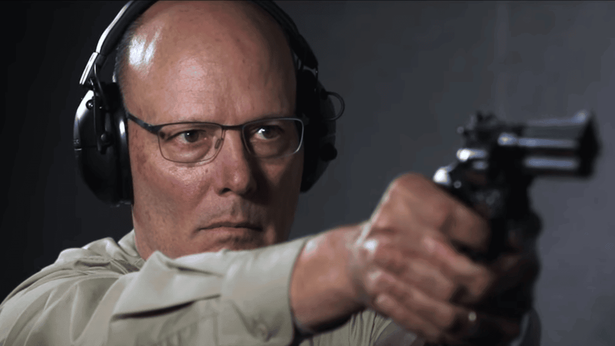 NRA CEO Doug Hamlin shooting a gun in a promotional video