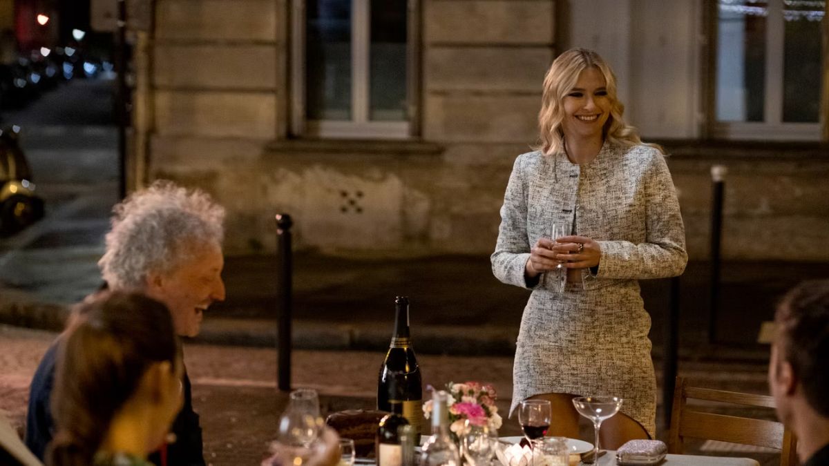 Camille Razat as Camille gives a toast at Emily's birthday dinner in Emily In Paris 