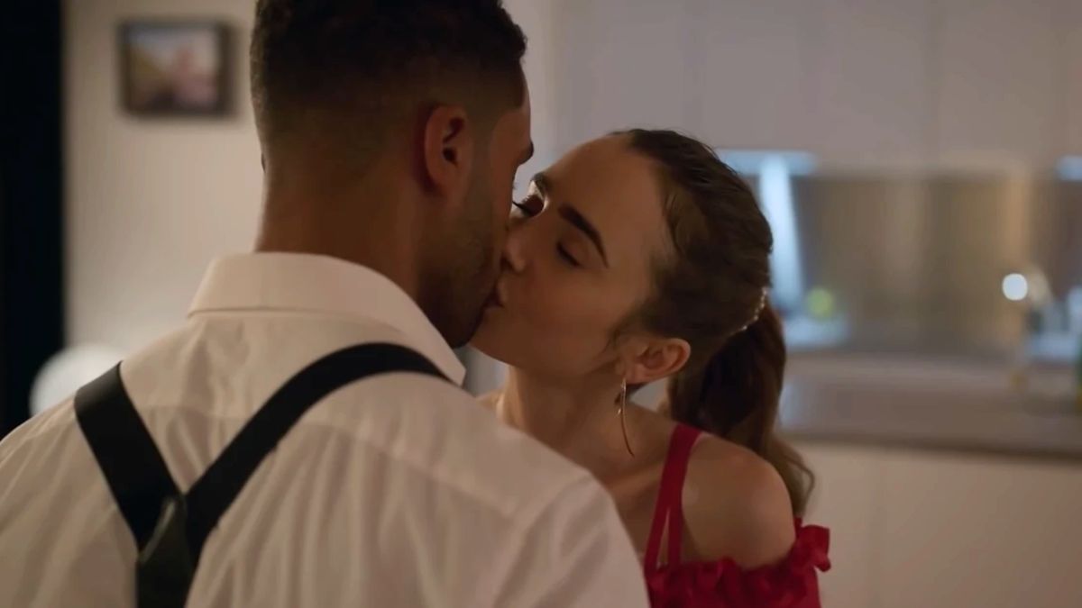 Lucien Laviscount as Alfie and Lily Collins as Emily kiss in Emily In Paris