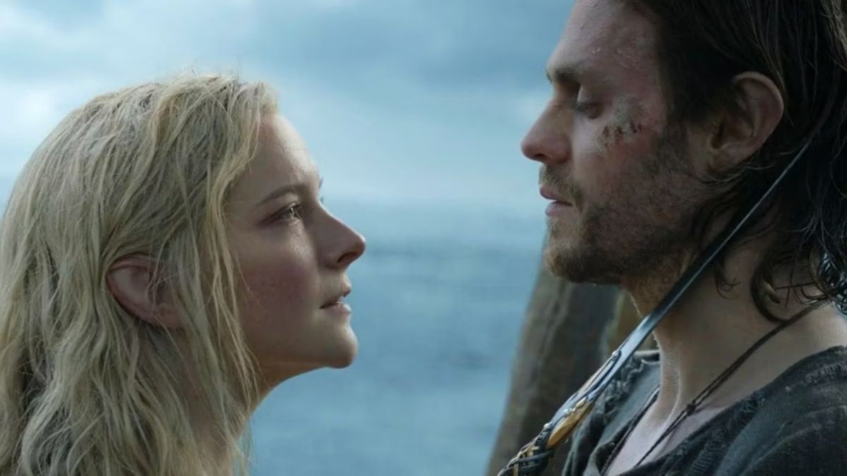 Morfydd Clark as Galadriel holds Charlie Vickers as Halbrand on knife point in Rings of Power season 1