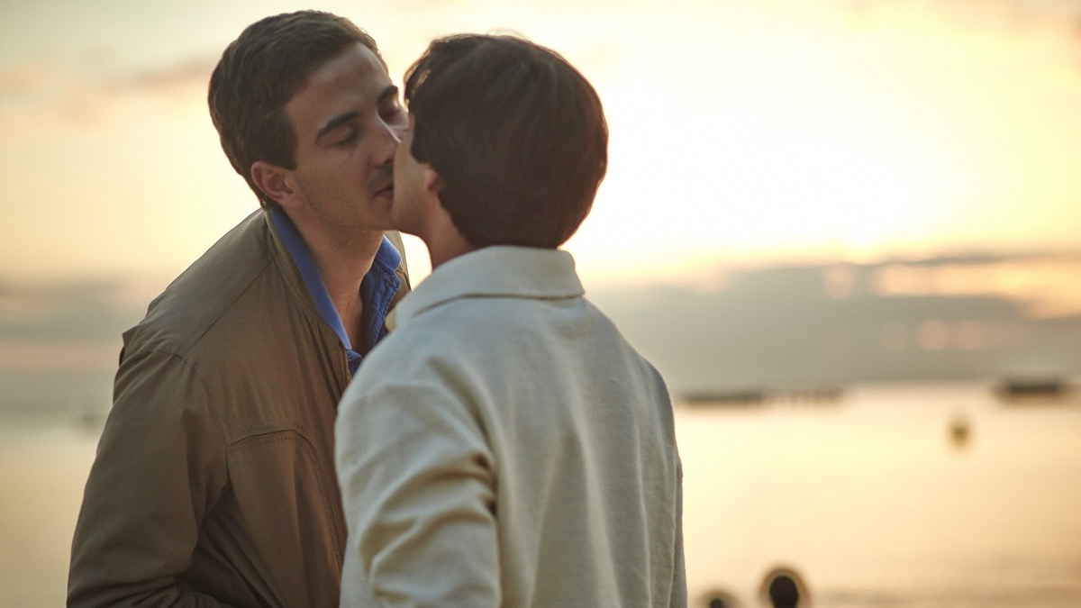 Two men kiss on a beach at sunset in "Holding the man"