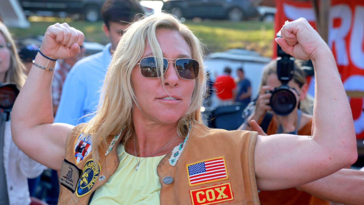 PLAINVILLE, GEORGIA - MAY 20: Rep. Marjorie Taylor Greene (R-GA) flexes her muscles during a Bikers for Trump campaign event held at the Crazy Acres Bar & Grill on May 20, 2022 in Plainville, Georgia. Rep. Greene is running for a second congressional term in the state's upcoming midterm primary. (Photo by Joe Raedle/Getty Images)