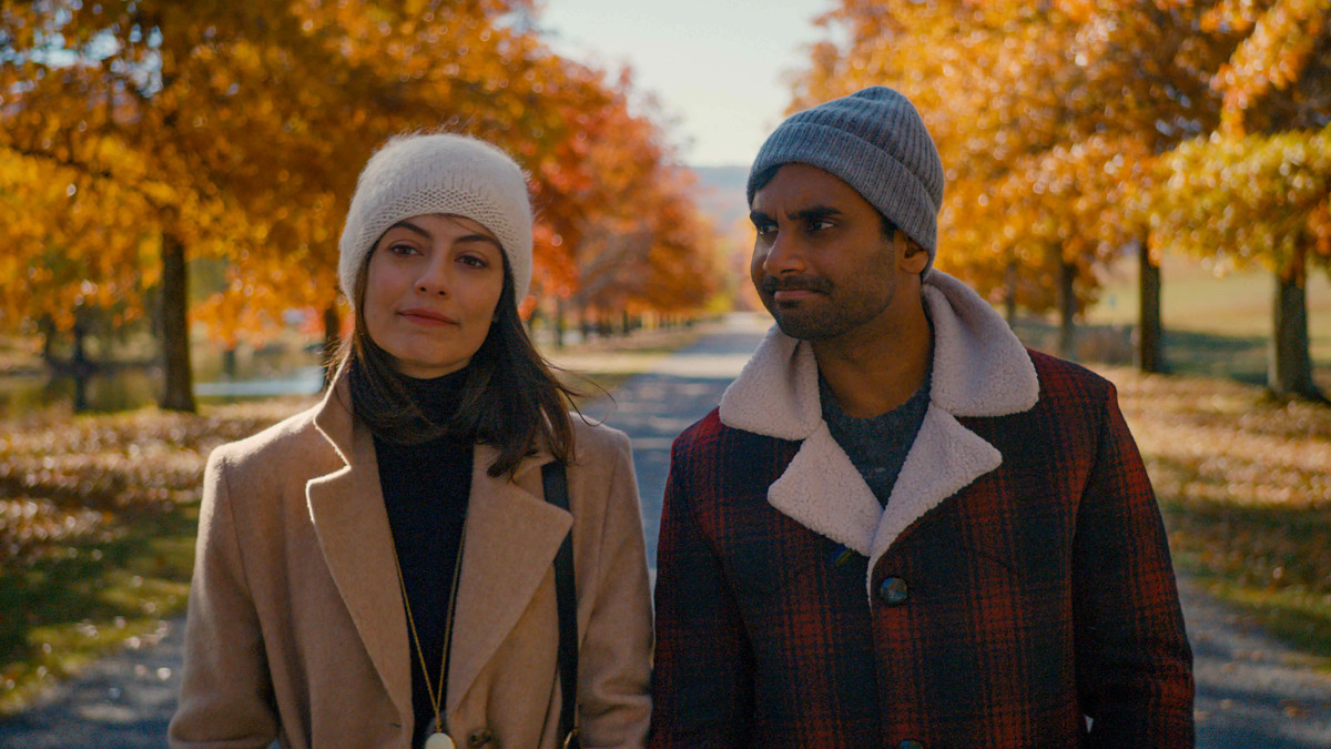 A still from Master of None on Netflix. A couple walks through a park in the fall. 