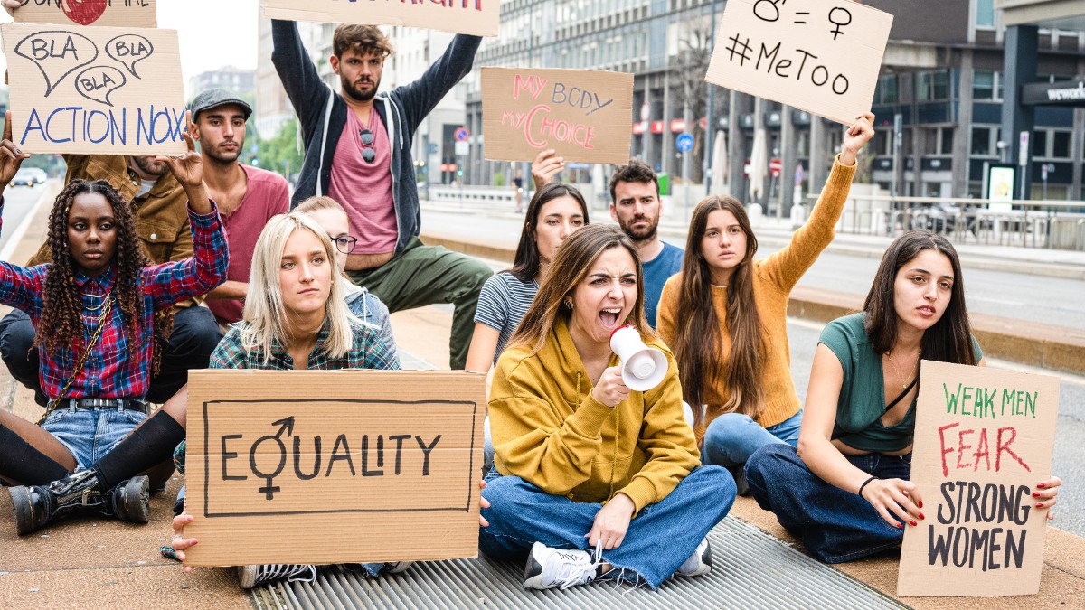 A group of men and women support the #MeToo movement and protest violence against women