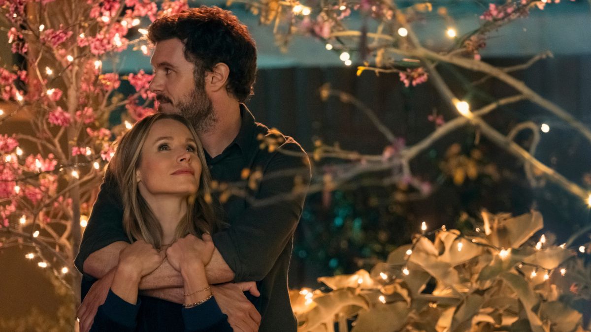 Adam Brody as Hot Rabbi Noah Roklov puts his arm around Kristen Bell's Joanne from behind in a scene from Nobody Wants This on Netflix