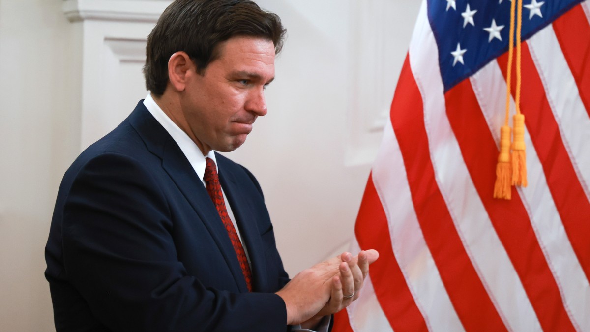 Florida Governor Ron DeSantis looking disappointed during a press conference