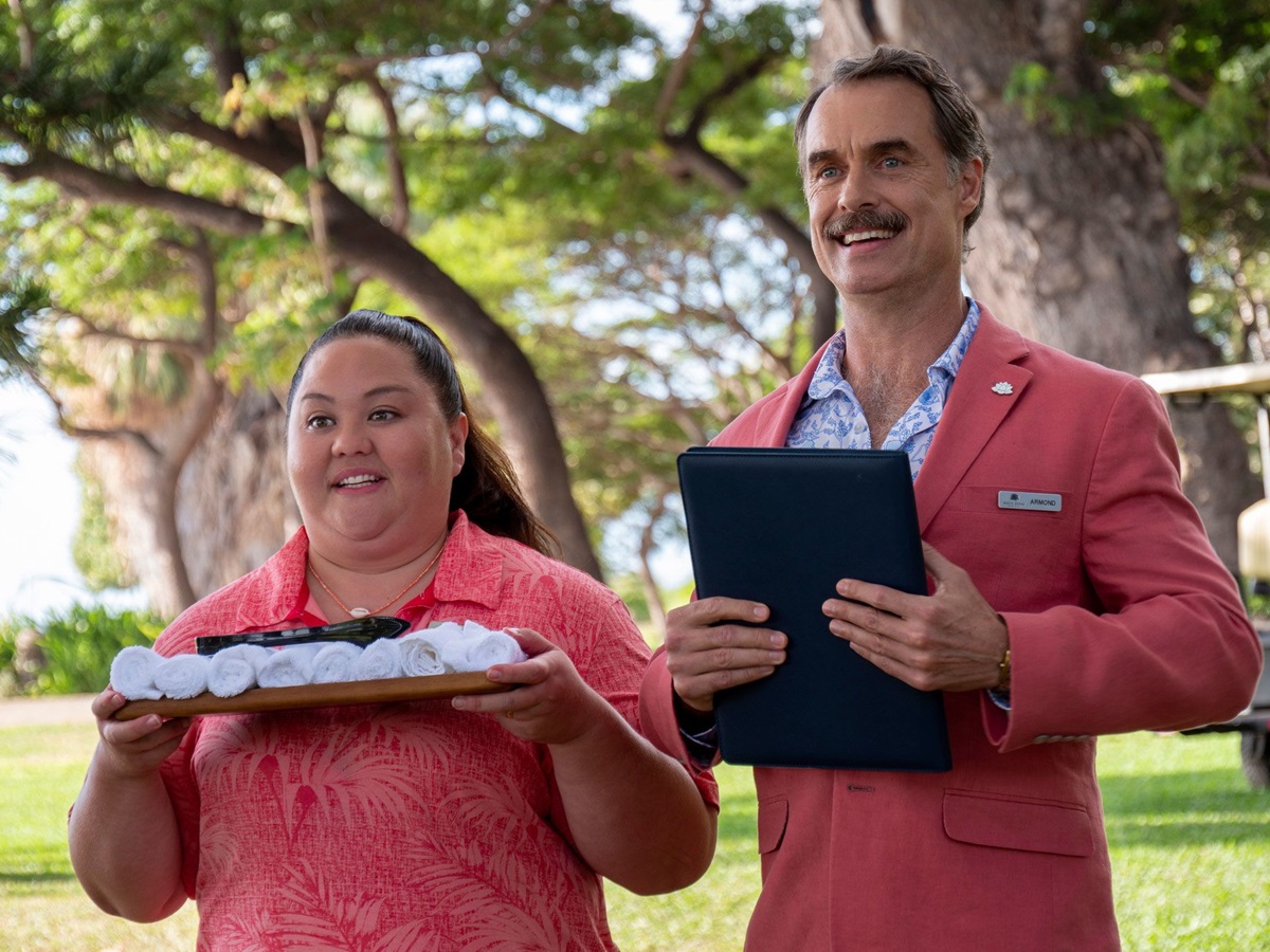 two hotel workers hold clipboards and look cheerful in 'The White Lotus' season 1 