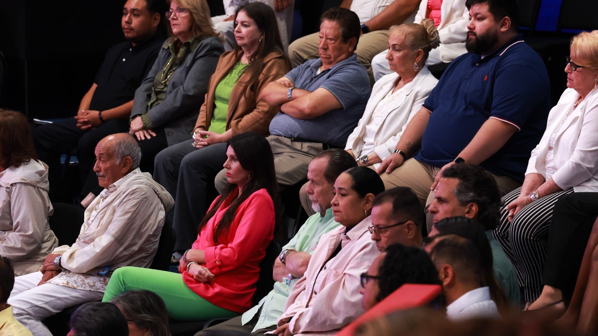 Undecided voters look on as Donald Trump speaks at the Univision Noticias town hall in Doral, FL