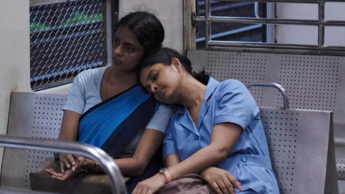 Seated in a train, Divya Prabha as Anu rests her head on the shoulder of Kani Kusruti as Prabha in All We Imagine As Light