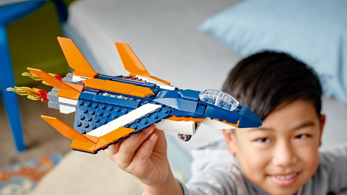 A child plays with a LEGO aircraft set