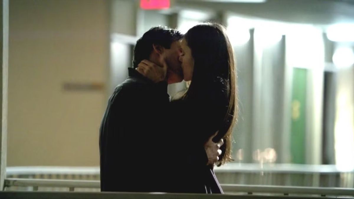 Damon and Elena passionately kiss in a Denver motel corridor in The Vampire Diaries