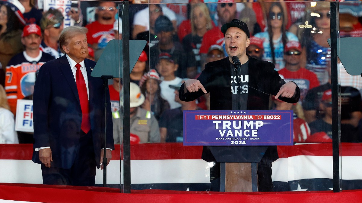 Donald Trump looks on as Elon Musk speaks to a crowd of Trump supporters in Butler, PA