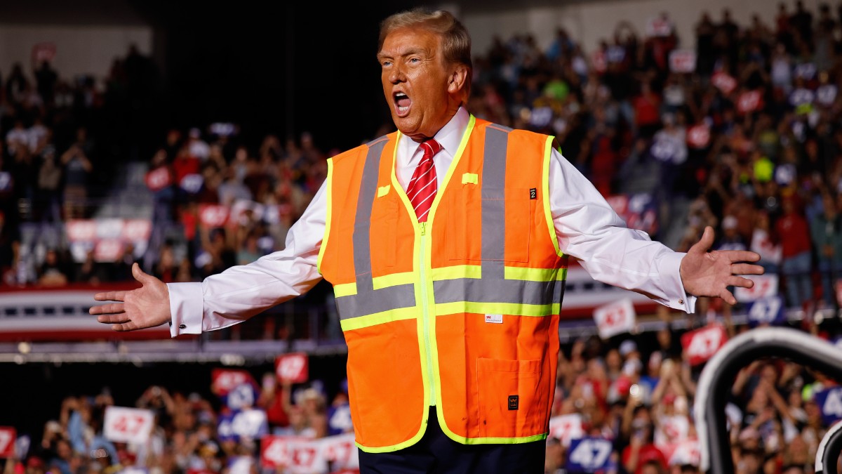 Donald Trump in a waste management costume speaking to supporters in Green Bay, WI