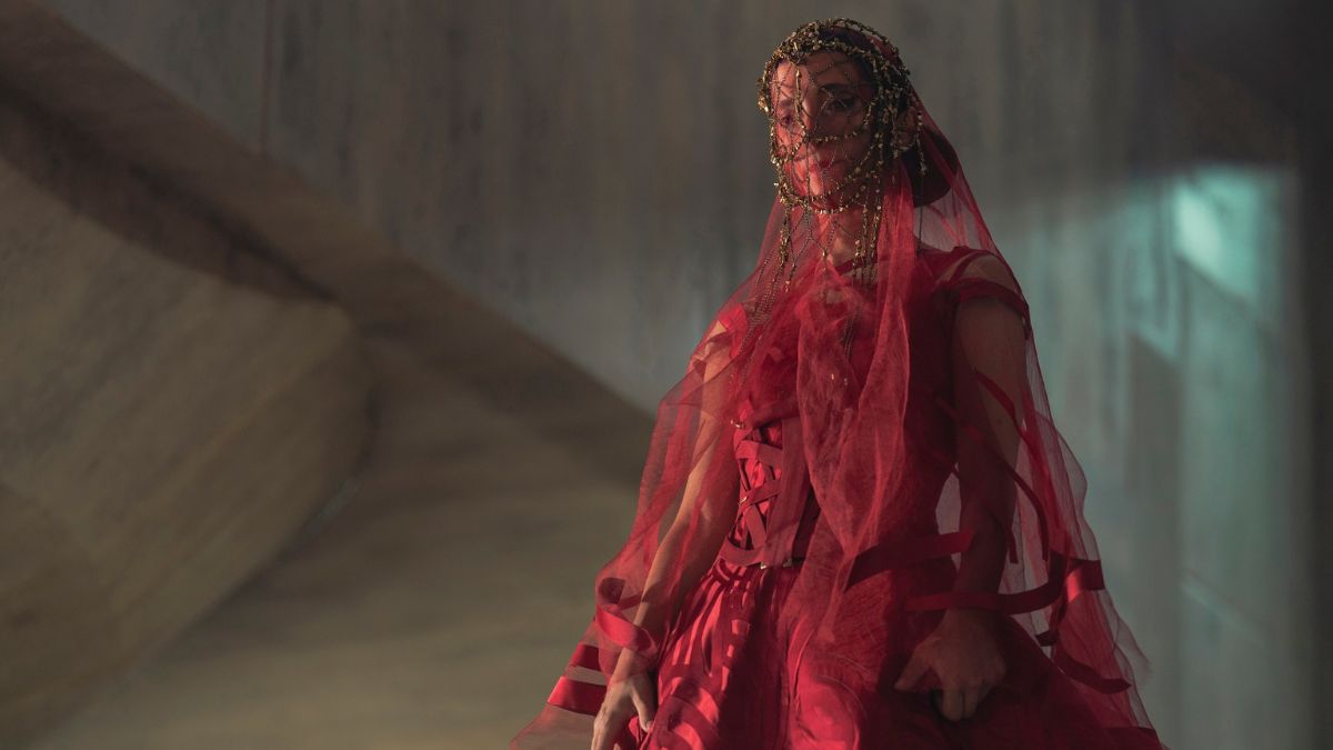 Sarah-Sofie Boussnina as Princess Inez Corrino clad in a red wedding gown with a veil in Dune: Prophecy episode 1