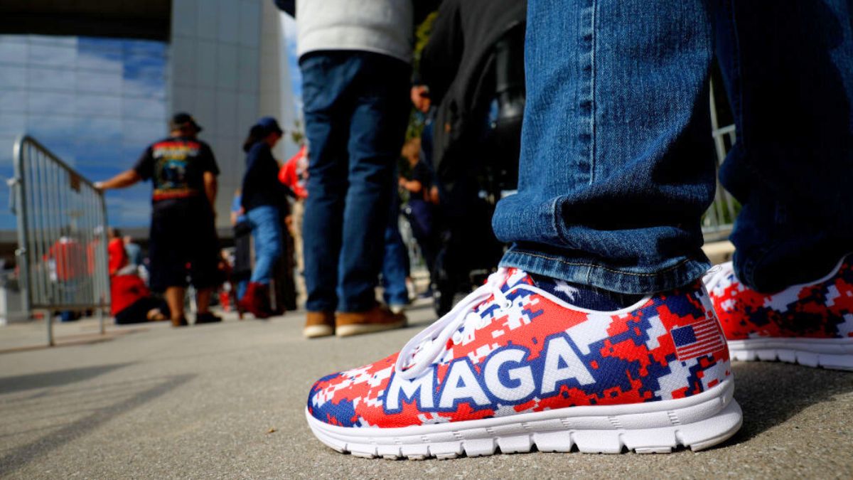 ATLANTA, GEORGIA - OCTOBER 15: A supporter wears "MAGA" shoes as he waits in line for a campaign rally for Republican presidential nominee, former U.S. President Donald Trump at the Cobb Energy Performing Arts Centre on October 15, 2024 in Atlanta, Georgia. With early voting starting today in Georgia both Trump and Democratic presidential nominee, Vice President Kamala Harris are campaigning in the Atlanta region this week as polls show a tight race. (Photo by Kevin Dietsch/Getty Images)