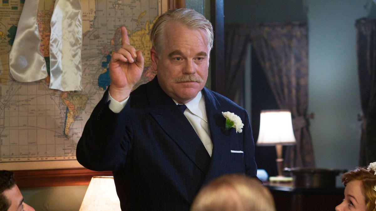 Philip Seymour Hoffman as Lancaster Dodd raises a finger in The Master