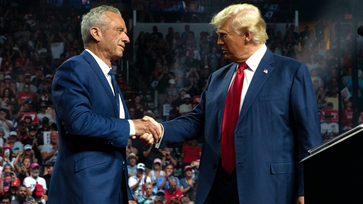 Robert F. Kennedy, Jr., and Donald Trump shake hands during a rally at the Desert Diamond Arena