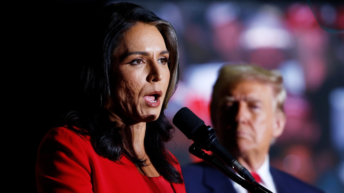 Tulsi Gabbard speaking at a Donald Trump rally in Greensboro, NC, as Trump looks on