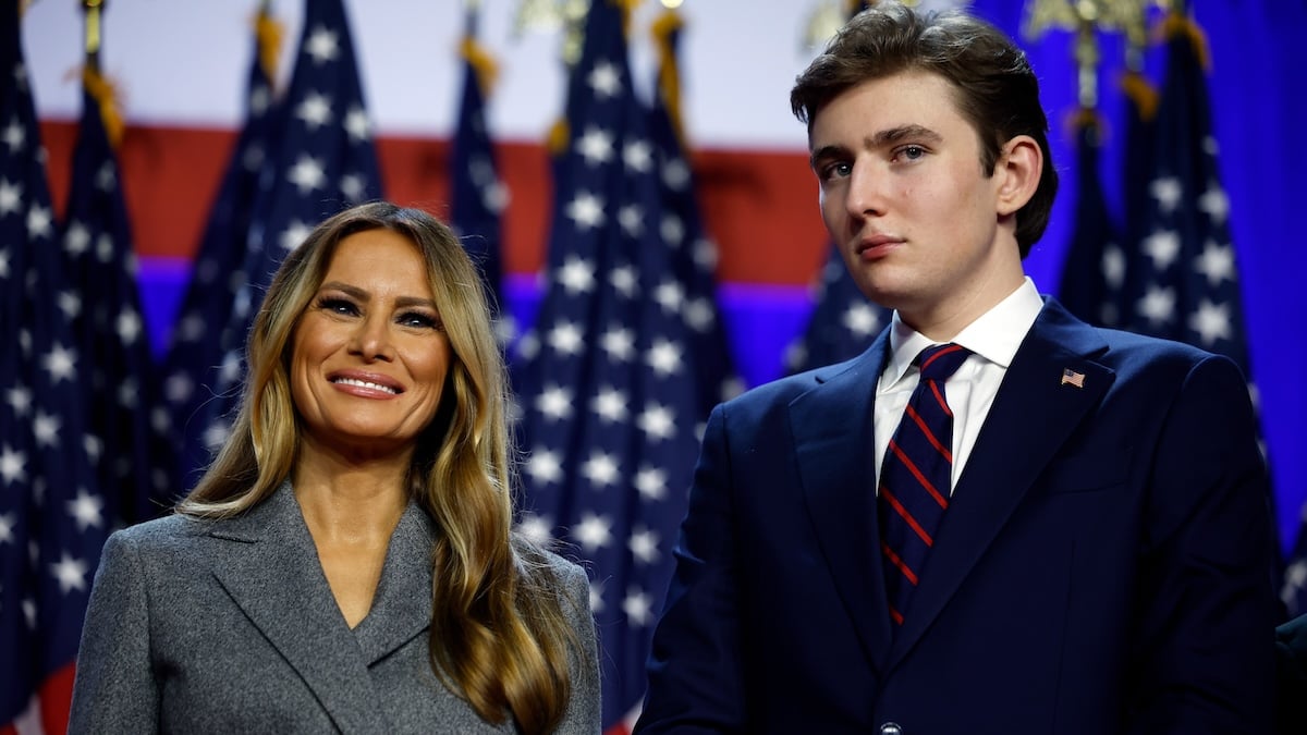 barron trump standing next to melania trump