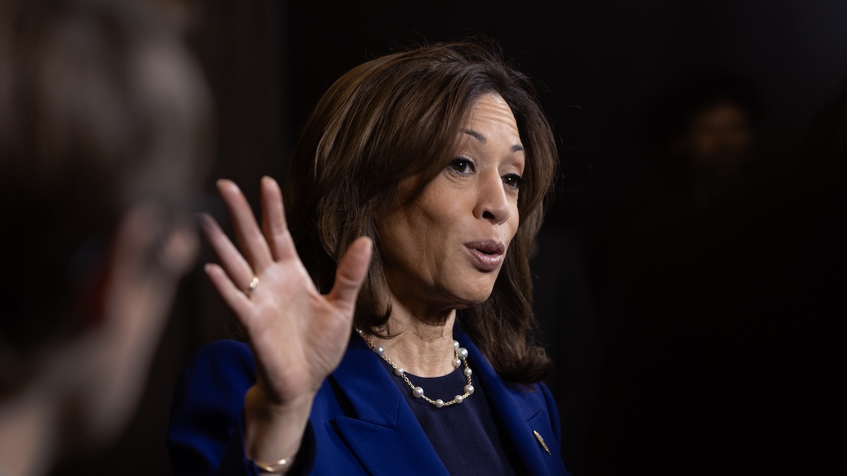 Kamala Harris standing with her hand up