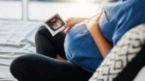 Closeup shot of an unrecognizable pregnant woman holding an ultrasound scan